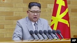 In this image made from video released by KRT on Jan. 1, 2018, North Korean leader Kim Jong Un delivers his annual address from an undisclosed location in North Korea. 