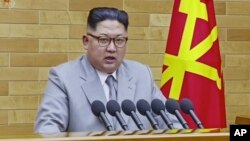 FILE - North Korean leader Kim Jong Un delivers his annual address, Jan. 1, 2018, from an undisclosed location in North Korea.