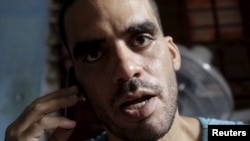 Cuban graffiti artist Danilo Maldonado speaks on his cellphone in his house in Havana, Oct. 20, 2015. Maldonado has been detained by the government after making a video celebrating the death of Fidel Castro.