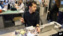 Mohammad Hazem Rezq, one of the Vogue staff works behind his desk at the magazine office at the Dubai Design District in Dubai, United Arab Emirates, March 15, 2017. 