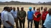 Governor of Sudan's Red Sea State Mustafa Mohammed Nour, center, stands with a group from the United Nations, Sudanese Red Crescent and Sudanese Red Cross in Port Sudan on Aug. 27, 2024. Humanitarian aid access has been restored through the northern Dabbah Road from Port Sudan.