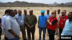 Governor of Sudan's Red Sea State Mustafa Mohammed Nour, center, stands with a group from the United Nations, Sudanese Red Crescent and Sudanese Red Cross in Port Sudan on Aug. 27, 2024. Humanitarian aid access has been restored through the northern Dabbah Road from Port Sudan.