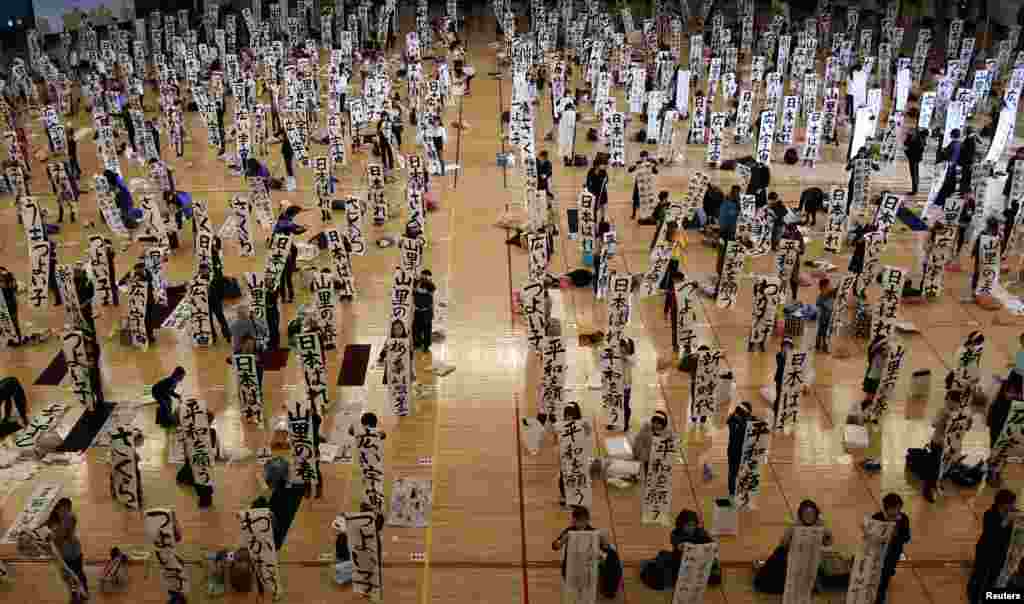 Participants show off their writing at a New Year calligraphy contest in Tokyo, Japan. 