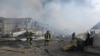 FILE - Firefighters put out the fire following a Russian drone attack that hit warehouses in Odesa, Ukraine, March 11, 2025. 