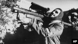 FILE - An Afghan guerrilla handles a U.S.-made Stinger anti-aircraft missile in this photo made between November 1987 and January 1988. 