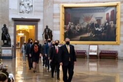 Acting Sergeant at Arms Timothy Blodgett, right, leads Rep. Jamie Raskin, D-Md., second from right, the lead Democratic House impeachment manager, and other impeachment managers, through the Rotunda to the Senate, Feb. 9, 2021.