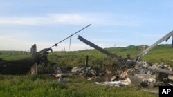 Remains of a downed Azerbaijani forces helicopter lies in a field in the separatist Nagorno-Karabakh region, April 2, 2016. Azerbaijan's Defense Ministry said one of its helicopters was shot down in heavy fighting Saturday between Armenian and Azerbaijani