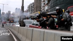 Riot police use rubber bullets to disperse anti-government protesters during a march against Beijing's plans to impose national security legislation in Hong Kong, China, May 24, 2020.