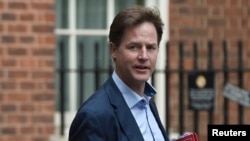 FILE - Then-British Deputy Prime Minister Nick Clegg arrives at Downing Street in London, Sept. 16, 2014. 