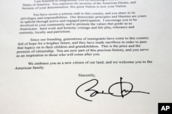 FILE - This September 16, 2016, photo, taken in Cary, N.C., shows a section of a letter from the White House welcoming Manasi Gopala as a U.S. citizen, signed by President Barack Obama.
