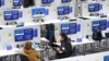 People sit inside the media room inside the Scottish Event Campus (SEC) in Glasgow, Scotland on Oct. 31, 2021, the venue of the COP26 UN Climate Change Conference. 