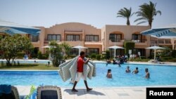 FILE - Tourists relax in a pool in the Red Sea resort of Hurghada, Egypt, August 15, 2016. 