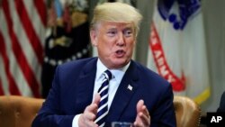 FILE - President Donald Trump speaks during talks on sanctuary cities with law enforcement officers in the Roosevelt Room of the White House, in Washington, March 20, 2018.