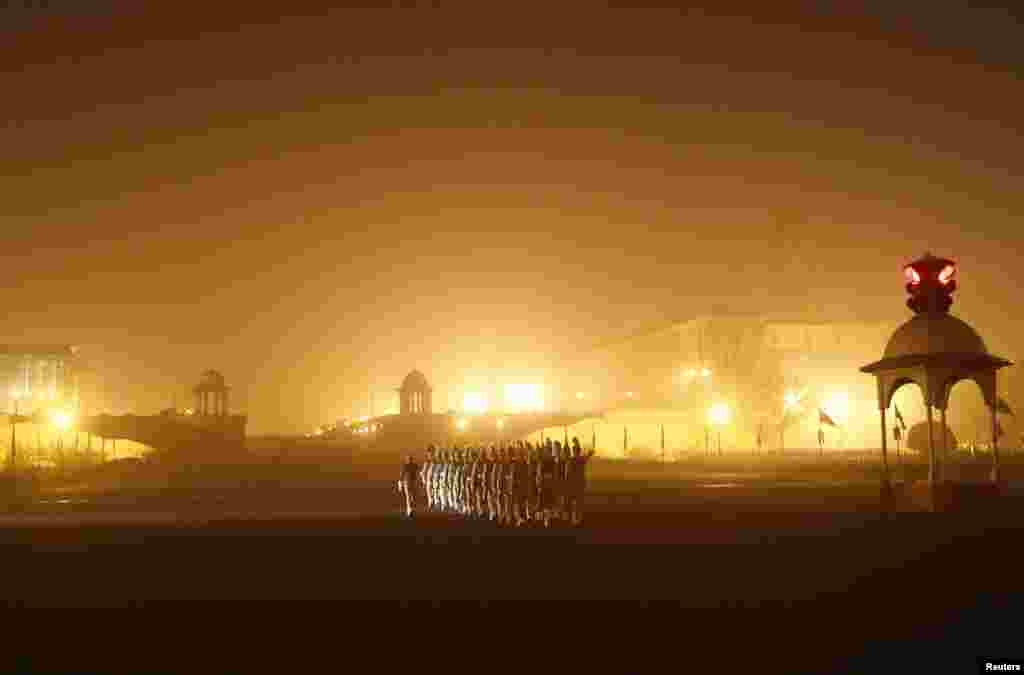 Indian soldiers march as they rehearse for the Republic Day parade amid fog on a cold winter morning in New Delhi.