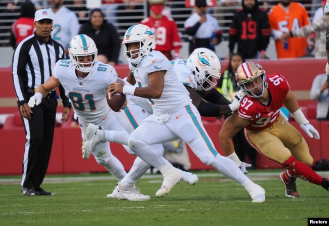 Miami Dolphins quarterback Tua Tagovailoa (1) escapes San Francisco 49ers defensive end Nick Bosa (97) during the first quarter at Levi's Stadium on Dec. 4, 2022. (Kelley L Cox-USA TODAY Sports)