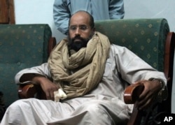 FILE - In this Nov. 19, 2011, file photo, Seif al-Islam is seen after his capture in the custody of revolutionary fighters in Zintan, a town south of the capital Tripoli, Libya.