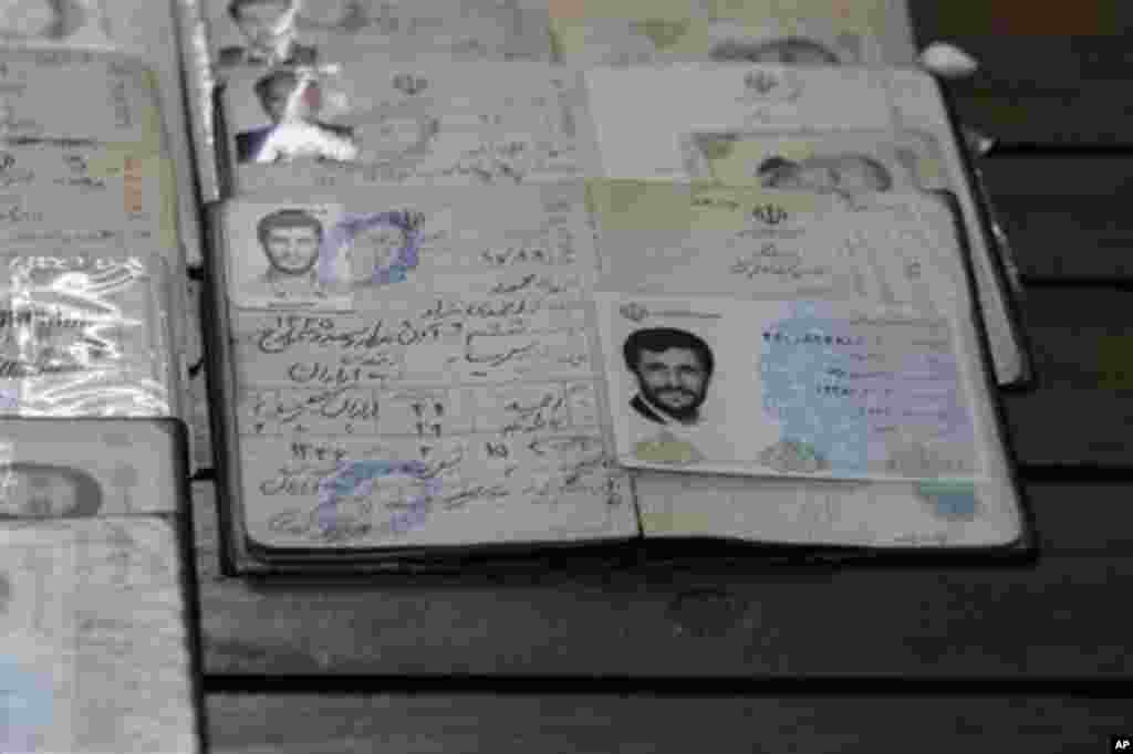 Identification document of the Iranian President Mahmoud Ahmadinejad is placed on a polling station table, during the parliamentary elections in downtown Tehran, Iran, Friday, March 2, 2012. The balloting for the 290-member parliament is the first major v