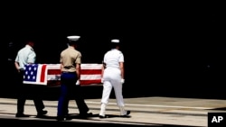 FILE - Members of the United States military carry a casket containing remains of U.S. Korean War soldiers turned over by North Korea, during a repatriation ceremony at Hickam Air Force Base in Hawaii, April 12, 2007. 