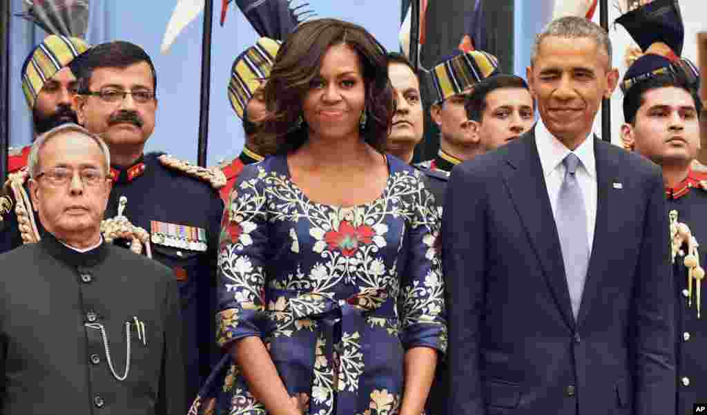 President Barack Obama, winks standing beside first lady Michelle Obama and Indian President Pranab Mukherjee during a receiving line before State Dinner at the Rashtrapati Bhavan, the presidential palace, in New Delhi, India, Jan. 25, 2015.