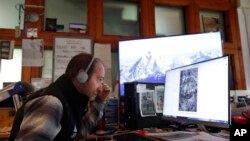 Glaciologist of Fondazione Montagna Sicura, Safe Mountain Foundation, Fabrizio Troilo, monitors computer images of the Planpincieux glacier, near Courmayeur, Italy, Sept. 26, 2019.