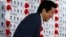 Japan's Prime Minister and leader of the ruling Liberal Democratic Party (LDP) Shinzo Abe smiles as he leaves an election campaign center at the LDP headquarters in Tokyo, July 21, 2013, after an upper house election. 