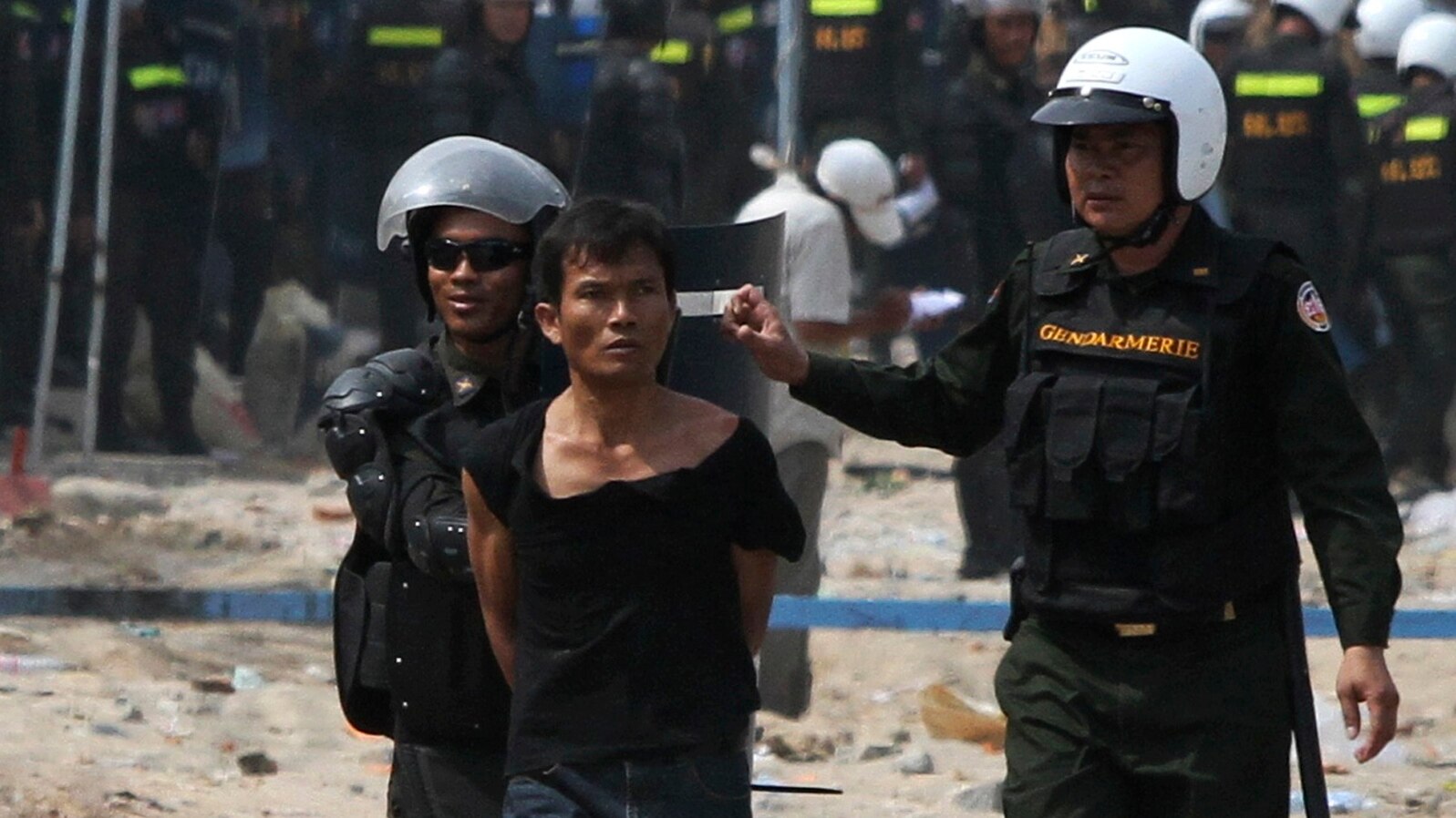 A protester is detained during clashes between garment workers and security forces in Phnom Penh a year ago, on January 3, 2014.