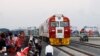 Kenyan President Uhuru Kenyatta, third from left, watches a cargo train carrying port containers begin its opening run from Mombasa to Nairobi, Kenya, May 30, 2017.