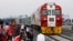 FILE - Kenyan President Uhuru Kenyatta watches a cargo train carrying port containers begin its opening run from Mombasa to Nairobi, Kenya, May 30, 2017. The project was financed by China.