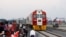 Kenyan President Uhuru Kenyatta, third from left, watches a cargo train carrying port containers begin its opening run from Mombasa to Nairobi, Kenya, May 30, 2017.