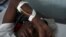 Givenchi Predelus suffers from Cholera at the Cholera Treatment Center run by the Haitian Ministry of Public Health and Population in collaboration with Doctors Without Borders, Port-au-Prince, Haiti, April 13, 2015.