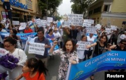 Demonstrators, holding signs to protest against Taiwanese enterprise Formosa Plastic