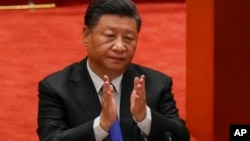 FILE - In this Oct. 9, 2021, photo, Chinese President Xi Jinping applauds during an event commemorating the 110th anniversary of Xinhai Revolution at the Great Hall of the People in Beijing. 
