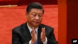 FILE - In this Oct. 9, 2021, photo, Chinese President Xi Jinping applauds during an event commemorating the 110th anniversary of Xinhai Revolution at the Great Hall of the People in Beijing.