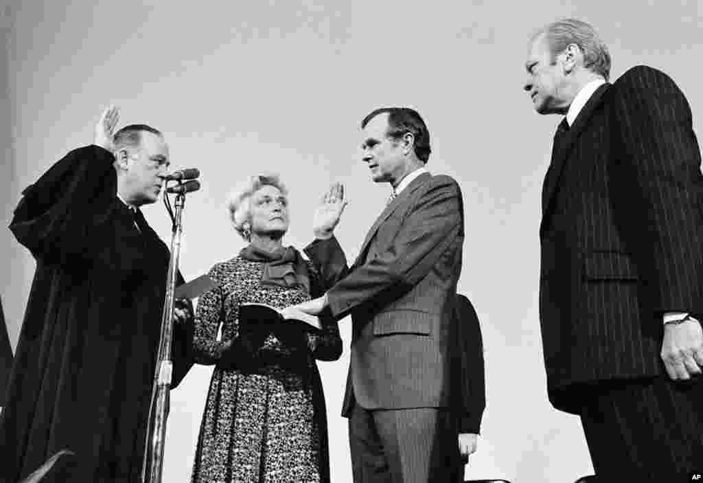 George Bush is sworn in as new director of the Central Intelligence Agency by Supreme Court Associate Justice Potter Stewart (left) as Mrs. Bush and President Gerald Ford look on at CIA headquarters in Langley, Va., Jan. 30, 1976.