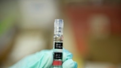 FILE - A nurse loads a syringe with a vaccine against hepatitis at a free immunization clinic for students before the start of the school year, in Lynwood, California, Aug. 27, 2013.