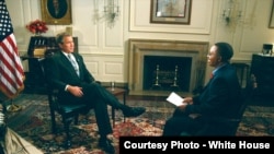 Vincent Makori interviews U.S. President George W. Bush at the White House in 2003. Makori did the interview before joining the president on a five-nation African trip.