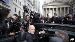 General Motors Co. CEO Daniel Akerson sits in the driver's seat of a 2011 Chevrolet Camaro parked in front of the New York Stock Exchange following GM's initial public offering, 18 Nov 2010