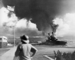 FILE - American ships burn during the Japanese attack on Pearl Harbor, Hawaii, in this Dec. 7, 1941 file photo.