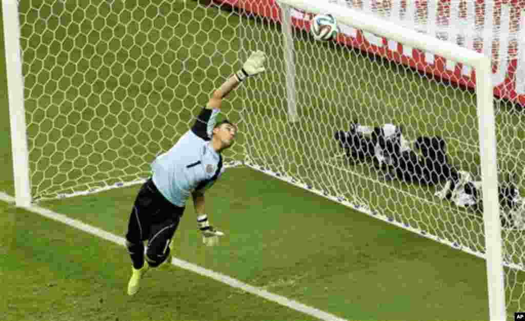 Costa Rica's goalkeeper Keylor Navas dives as the ball hits the bar during the World Cup quarterfinal soccer match between the Netherlands and Costa Rica at the Arena Fonte Nova in Salvador, Brazil, Saturday, July 5, 2014. (AP Photo/Themba Hadebe)