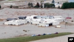 In this photo from video, people can be seen on the roof of the Unicoi County Hospital in Erwin, Tennessee, on Sept. 27, 2024. (NewsNation via AP)