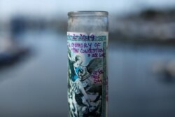 A candle in memory of lives lost on the dive boat Conception sits at a makeshift memorial near boat owner Truth Aquatics, in Santa Barbara, Calif., Sept. 3, 2019.