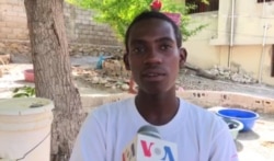 Haitian teen inventor Wens Dimanche invented a way for his neighbors to wash their hands without risking COVID-19 contamination. (Photo: Matiado Vilme / VOA)