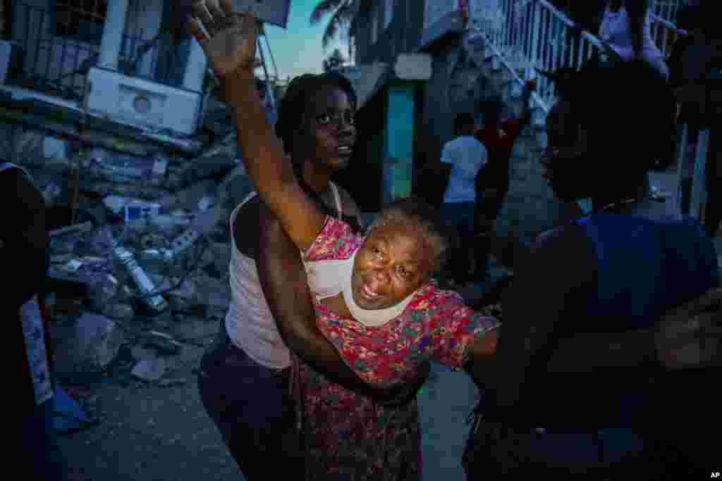 Oxiliene Morency grieves after the body of her 7-year-old-daughter Esther Daniel was recovered from the rubble of their home destroyed by the earthquake in Les Cayes, Haiti, Aug. 14, 2021.