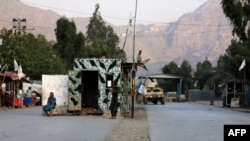 Taliban security personnel stand guard near the closed gates of Torkham border crossing between Afghanistan and Pakistan in Afghanistan's eastern Nangarhar province on Sept. 6, 2023.