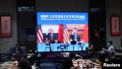 Una pantalla transmite una reunión virtual entre los presidentes de EE. UU., Joe Biden, y China, Xi Jinping, en un restaurante de Beijing el 15 de noviembre de 2021.