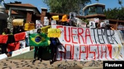 FILE - Demonstrators protest outside the Olivos presidential residence against the visit of Brazilian President Michel Temer in Buenos Aires, Argentina, Oct. 3, 2016.