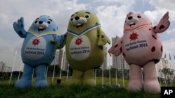 Three official mascots of the the 2014 Incheon Asian Games, from left, Barame, Vichuon and Chumuro pose for a photo at the 17th Asian Games Athletes' Village in Incheon, west of Seoul, South Korea, Aug. 26, 2014.
