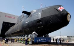 FILE - Britain's Royal Navy nuclear-powered submarine HMS Astute is launched at the Devonshire Dock Hall in Barrow-in-Furness, northwest England, June 8, 2007.