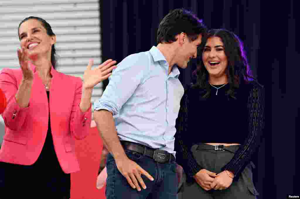 Canada&#39;s Prime Minister Justin Trudeau speaks with U.S. Open tennis champion Bianca Andreescu as Minister of Science and Sport Kirsty Duncan (left) looks on at the &quot;She The North&quot; celebration rally for Andreescu in Mississauga, Ontario, Sept. 15, 2019.