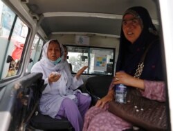 Afghan women sit in an ambulance after being rescued by security forces during an attack and gunfire at a hospital in Kabul, May 12, 2020.